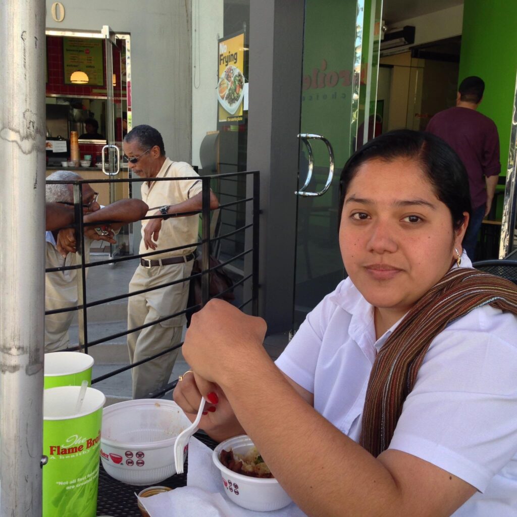 Analitika interviewer eating lunch on a restaurant patio in Los Angeles